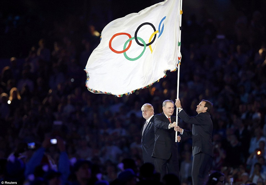 London mayor Boris Johnson passes the Olympic Flag to Rio de Janeiro Mayor Eduardo Paes, helped by IOC president Jacques Rogge Read more: http://www.dailymail.co.uk/news/article-2187413/London-2012-Closing-Ceremony-Feeling-sad-end-Games-Eric-Idle-leads-80-000-crowd-rendition-Always-Look-Bright-Side-Life.html#ixzz23O8oRE45