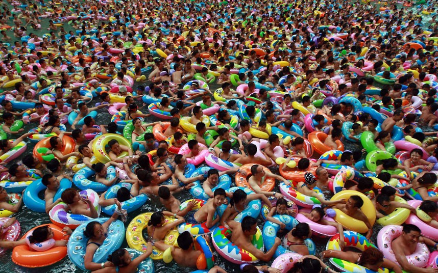 Swimmers wait for the gush of a man-made tide in a salty swimming pool dubbed China’s Dead Sea, in Daying county in southwest China’s Sichuan province