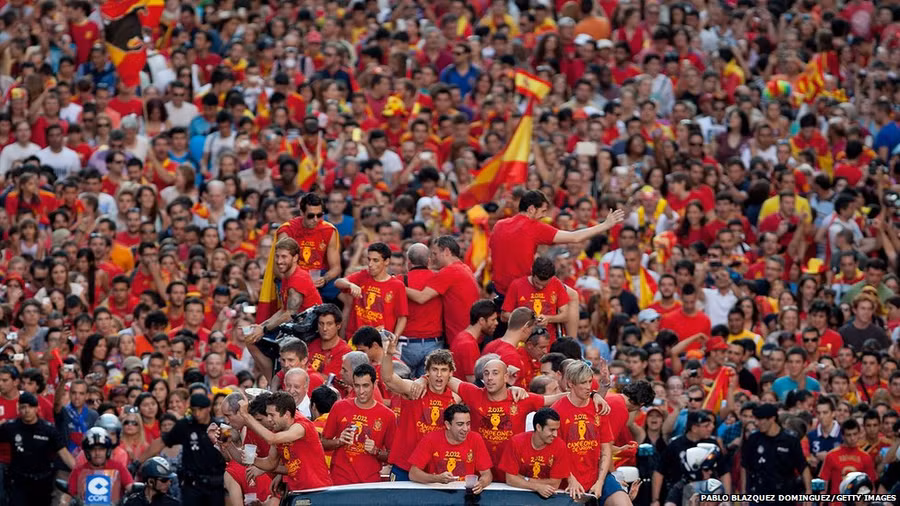 Spain’s players celebrate with their fans and the Uefa Euro 2012 trophy on a double-decker bus parade in Madrid. Spain beat Italy 4-0 in the final in Kiev, Ukraine.