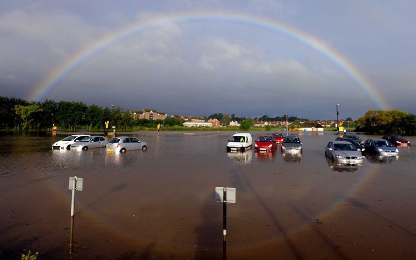 A rainbow forms above a flooded car park in Weymouth, Dorset 