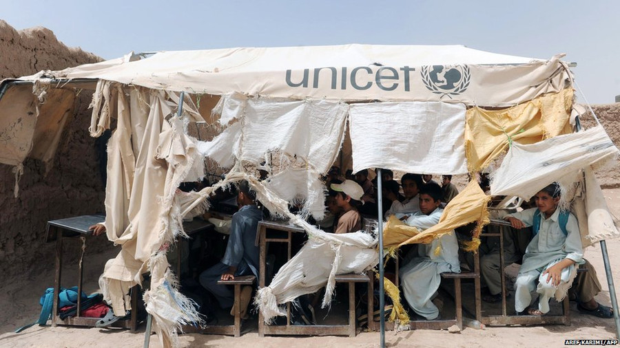 Afghan children study in a temporary classroom a day after their school came under fire by unidentified gunmen in Herat.