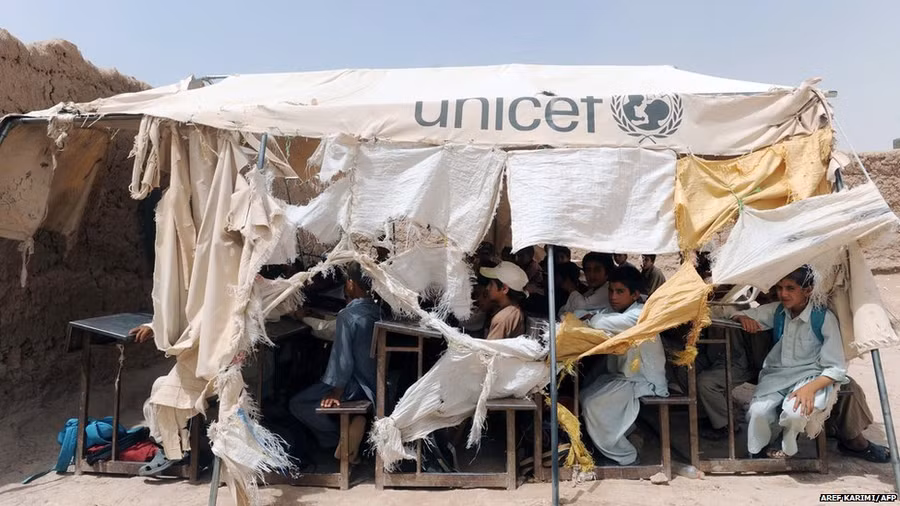 Afghan children study in a temporary classroom a day after their school came under fire by unidentified gunmen in Herat.
