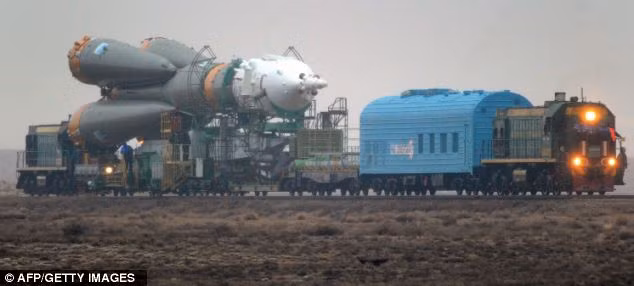 The Soyuz TMA-21 rocket is moved to the launch pad by railcar Read more: http://www.dailymail.co.uk/sciencetech/article-1372645/Russia-prepares-launch-Soyuz-space-ahead-50th-anniversary-manned-flight-Yuri-Gagarin.html#ixzz1ITSo3K00