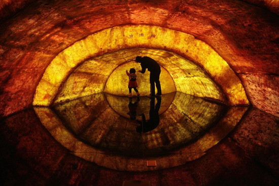 [CHINA] A woman and her daughter touch a structural model of the earth’s core at Nanjing Geological Museum in Nanjing, Jiangsu province April 22, 2011. Earth Day, which is celebrated on April 22 every year, marks an annual effort to raise public awareness about the environment and inspire actions to clean it up. The Chinese characters on the model read 