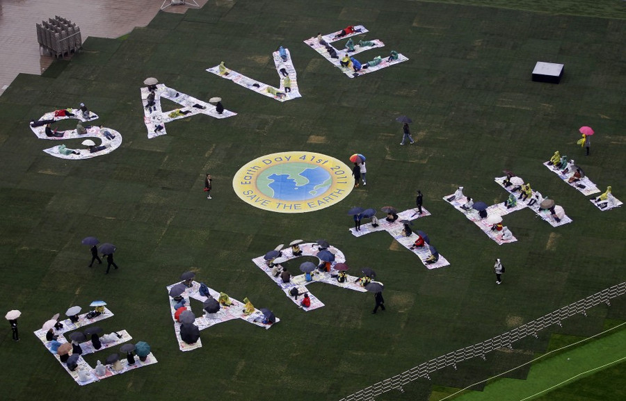 [SOUTH KOREA] Environmental activists and participants take part in a performance to mark World Earth Day at the Seoul City Hall plaza in central Seoul April 22, 2011. Earth Day marks an annual effort to raise public awareness about the environment and inspire actions to clean it up. Read more: http://www.ibtimes.com/articles/137279/20110422/world-earth-day-world-starbucks.htm#ixzz1KJkeiaNs