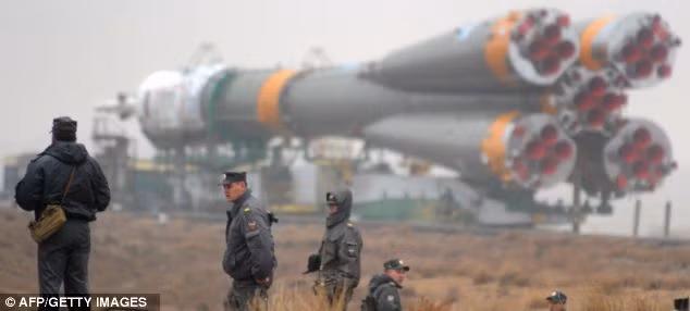 The rocket is surrounded by security before launch as it is moved into position Read more: http://www.dailymail.co.uk/sciencetech/article-1372645/Russia-prepares-launch-Soyuz-space-ahead-50th-anniversary-manned-flight-Yuri-Gagarin.html#ixzz1ITTLtgGN
