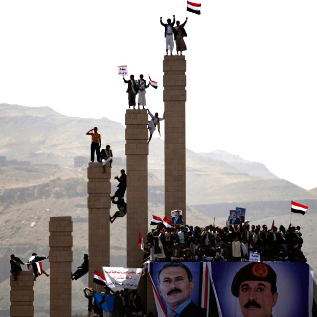 Supporters of Yemen’s President Ali Abdullah Saleh stand on pillars during a rally to show their support, in Sanaa