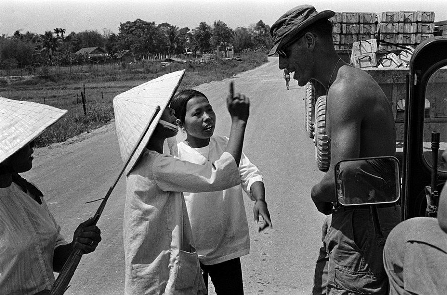 Community relations: A G.I. talks to Vietnamese natives on the road while escorting a supply convoy. An estimated four million civilians died in the bloody conflict which spanned two decades Read more: http://www.dailymail.co.uk/news/article-2303845/Never-seen-images-Vietnam-War-eyes-soldier-hid-photographs-decades.html#ixzz2PYZScxGv Follow us: @MailOnline on Twitter | DailyMail on Facebook