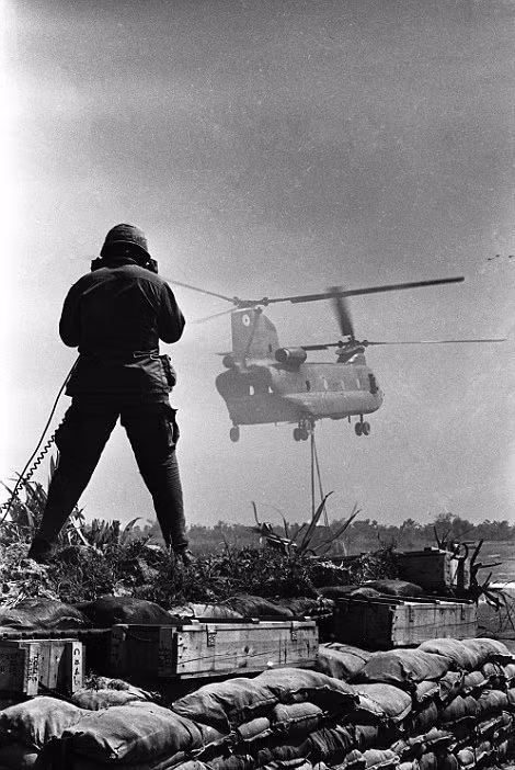 Relief: A medic gives Vietnamese children a shower using a Lyster Bag (left). Right, a soldier guides a Chinook delivering materials to Fire Support Base Pershing near Dau Tieng Read more: http://www.dailymail.co.uk/news/article-2303845/Never-seen-images-Vietnam-War-eyes-soldier-hid-photographs-decades.html#ixzz2PYZ9CsVH Follow us: @MailOnline on Twitter | DailyMail on Facebook
