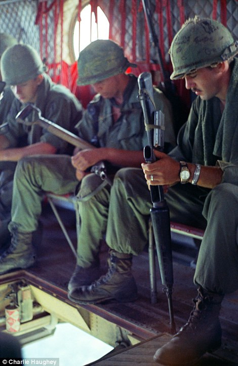 Vietnamese children peer through a gate at the American photographer during his tour which took place from 1968-9 (left) while soldiers look pensive as they are transported in a Chinook over Vietnam (right) Read more: http://www.dailymail.co.uk/news/article-2303845/Never-seen-images-Vietnam-War-eyes-soldier-hid-photographs-decades.html#ixzz2PYYNIRQ5 Follow us: @MailOnline on Twitter | DailyMail on Facebook