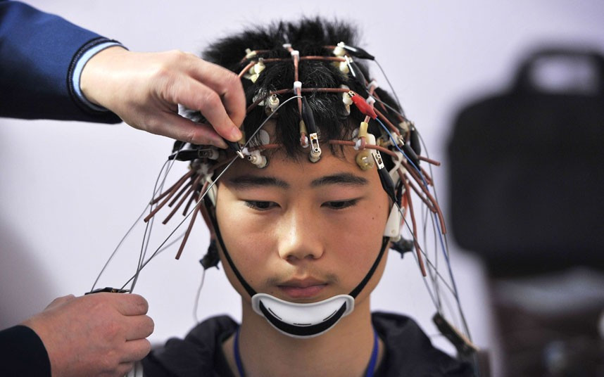 An examinee takes an electroencephalogram test during a military pilot selection in Wuhan, Hubei province. Around 500 high school graduates and university students took part in a series of physical examinations for the annual local military pilot recruitment exercise