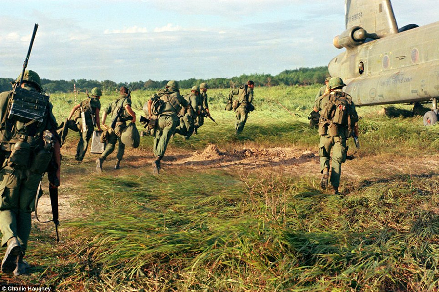 Evocative: This photograph showing American soldiers boarding a Chinook helicopter is one of 2,000 taken by Charlie Haughey during his tour of duty Read more: http://www.dailymail.co.uk/news/article-2303845/Never-seen-images-Vietnam-War-eyes-soldier-hid-photographs-decades.html#ixzz2PYXtdSQ2 Follow us: @MailOnline on Twitter | DailyMail on Facebook