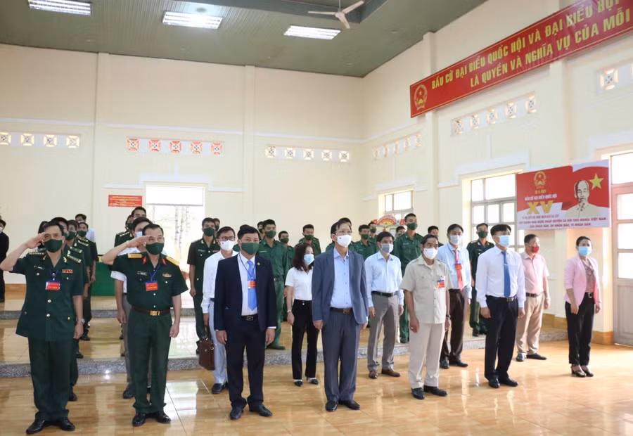 Các cử tri là CBCS Đồn Biên phòng cửa khẩu Đắk Ruê thực hiện nghi lễ chào cờ trước khi bỏ phiếu bầu ĐBQH khóa XV và ĐBHĐND nhiệm kỳ 2021-2026.