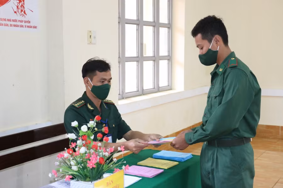 Cử tri là chiến sĩ Bộ đội Biên phòng nhận phiếu bầu từ Ban bầu cử.