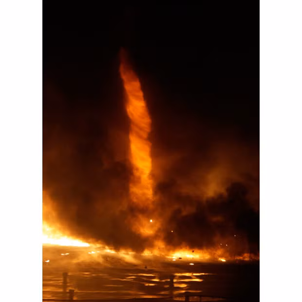 A fire tornado is seen during a huge blaze at a plastic processing factory in Kistarcsa, east of Budapest, Hungary