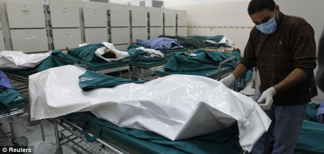 Libyan officials say these are the bodies of civilians and soldiers killed by Western forces in Tripoli Read more: http://www.dailymail.co.uk/news/article-1369452/Libya-Fighter-jets-shoot-Gaddafi-warplane-regimes-troops-parade-charred-bodies.html#ixzz1HWnffmxT