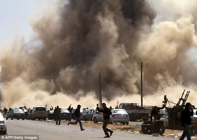 Rebel fighters run for cover as a bomb dropped by a fighter jet explodes near Ras Lanuf Read more: http://www.dailymail.co.uk/news/article-1363780/U-S-asks-Saudi-Arabia-supply-Libyan-rebels-weapons-bids-oust-Gaddafi.html#ixzz1FvTRUltO