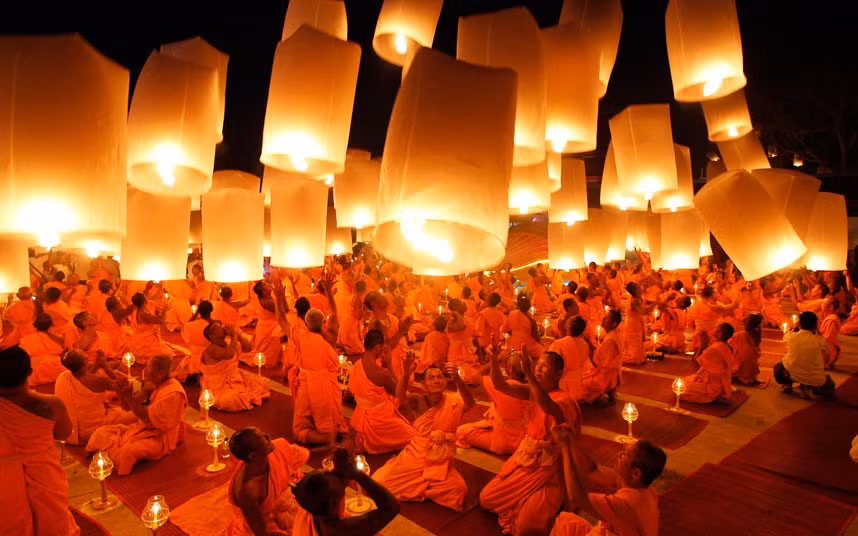 Buddhist monks launch paper lanterns into the sky at a temple in Suphan Buri province during a traditional pilgrimage to pay homage to Lord Buddha and bless Thailand as it enters the new year