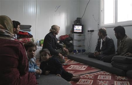 yrian refugees watch a television broadcast of Syria’s President Bashar al-Assad speaking in Damascus, in their container at the Al-Zaatari refugee camp in the Jordanian city of Mafraq, near the border with Syria, January 6, 2013.