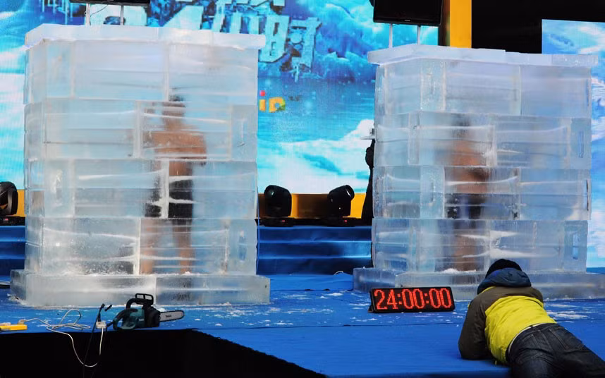 Two men spend 24 hours without food or water while trapped inside two large blocks of ice. Cui Deyi and Wang Baoyu were dressed only in shorts. The temperature inside the blocks was measured at -5 degrees centigrade (23 F). They emerged 24 hours later to the cheers of spectators who had gathered to witness the feat. Both men were found to be in good condition following their ordeal. They had both pulled off impressive cold-water stunts prior to this one: Cui holds a world record in winter-swimming, and Wang, a dentist by profession, holds several records for low-temperature feats of survival.