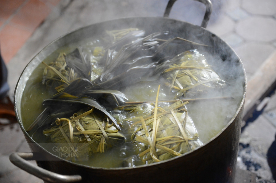 Nồi bánh chưng tỏa hương thơm nức cả một khu phố, khói bếp nồng nàn cứ vương vấn từ nhà này sang nhà khác khiến đôi ba câu chuyện từ những người đang ngồi chờ bánh chín trên vỉa hè Hà Nội lại càng thêm rộn ràng hơn.