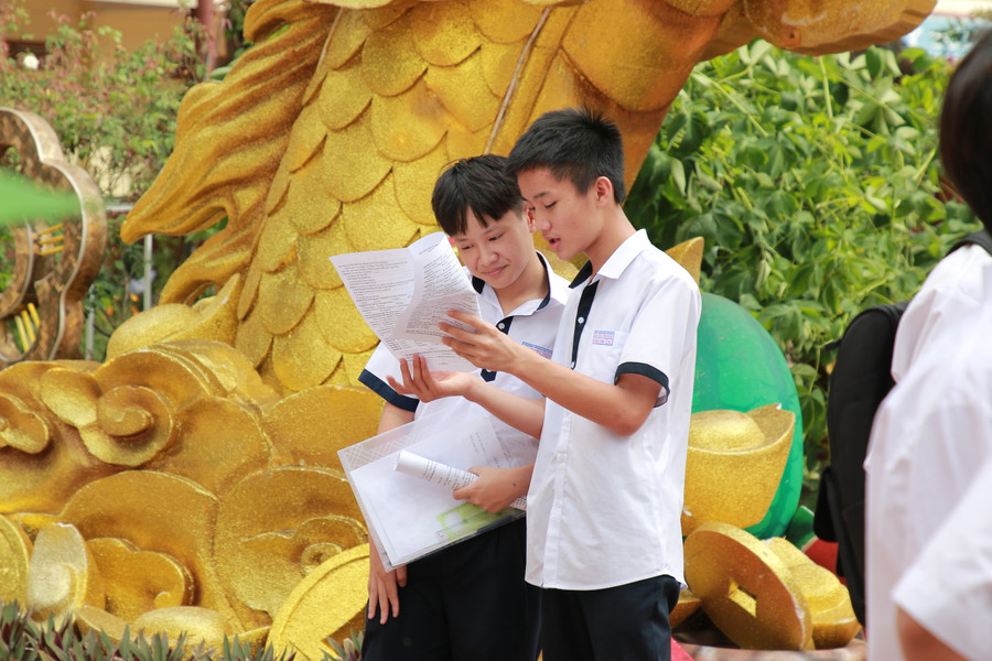 2 thí sinh tại điểm thi Trường THPT Lê Quý Đôn tranh thủ trao đổi lại đề thi. (Ảnh: TT) 2 thí sinh tại điểm thi Trường THPT Lê Quý Đôn tranh thủ trao đổi lại đề thi. (Ảnh: TT)