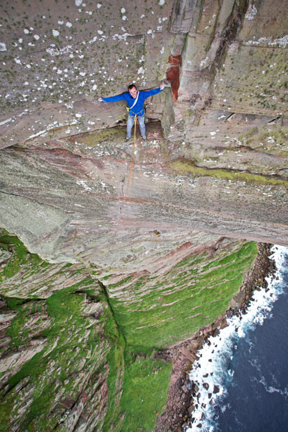 Daredevil Dave MacLeod perches on a rock face 1,000 feet up the world’s hardest sea cliff climb. The Scotsman became the first person to freeclimb St John’s Head on the Isle of Hoy, Scotland - widely believed to be the world’s hardest sea cliff climb. He took time out half way up to check out the breathtaking views from a two-foot wide ledge.