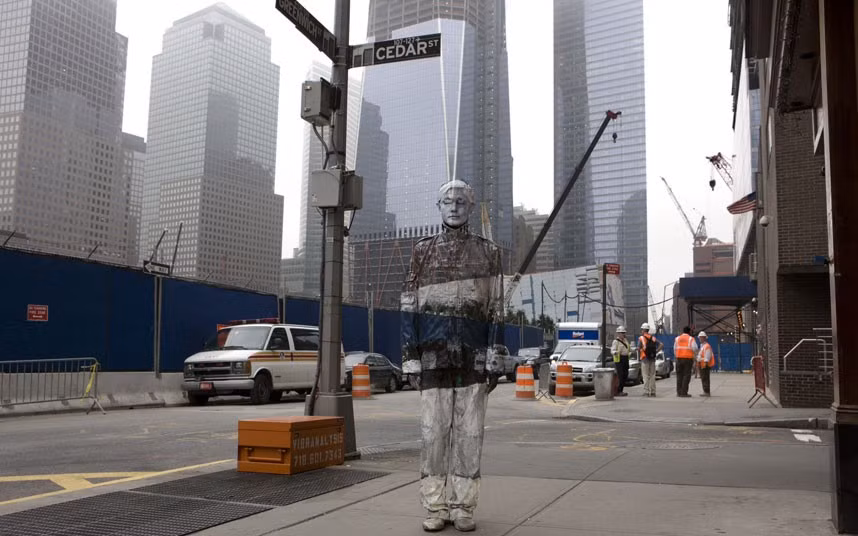 ...Liu Bolin has unveiled his new Ground Zero and Tiles for America art, standing in front of the new Freedom Tower, which replaced the Twin Towers in New York. Liu Bolin has received international acclaim for his technique of cleverly painting himself to blend in with the background.
