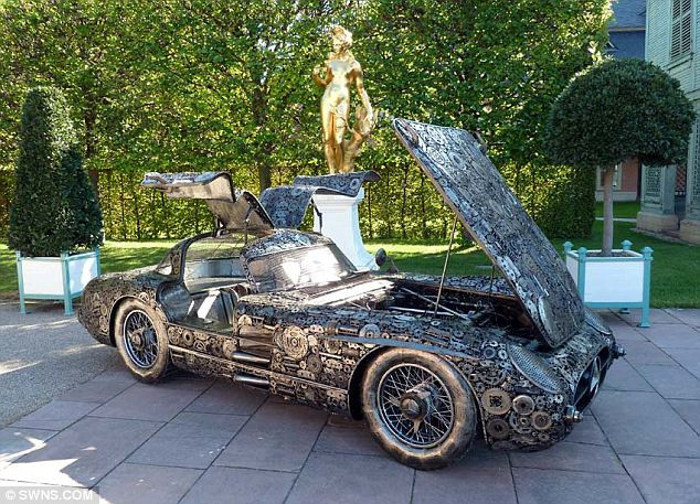 The German team behind the reproduction spent seven months constructing the sculpture out of 10,000 pieces of scrap Read more: http://www.dailymail.co.uk/news/article-2038819/Mercedes-classic-300-SLR-10-000-bits-recycled-metal.html#ixzz1YMXTSRRQ