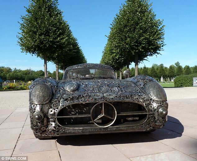 The Mercedes 300 SLR ’Uhlenhaut Coupe’ recreated from scrap metal Read more: http://www.dailymail.co.uk/news/article-2038819/Mercedes-classic-300-SLR-10-000-bits-recycled-metal.html#ixzz1YMXK5w8o