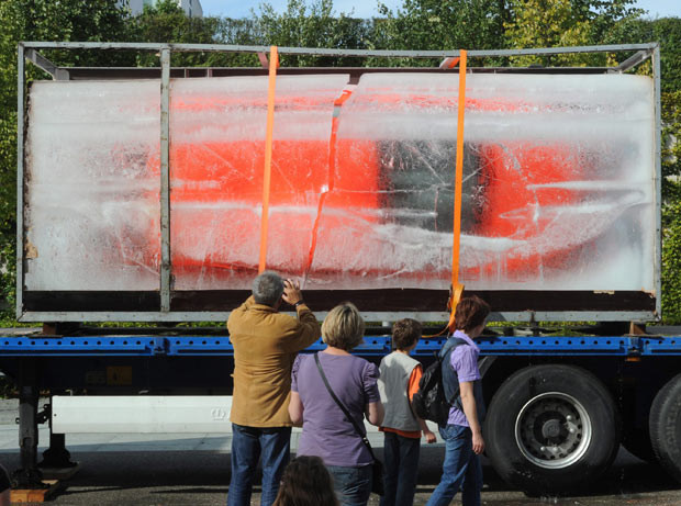 Passers-by look at a Ford Fiesta frozen in a block of ice in front of the Centre for Art and Media in Karlsruhe,Germany, a work by the German conceptual artist HASchult. The car will slowly thaw over the next few weeks. 