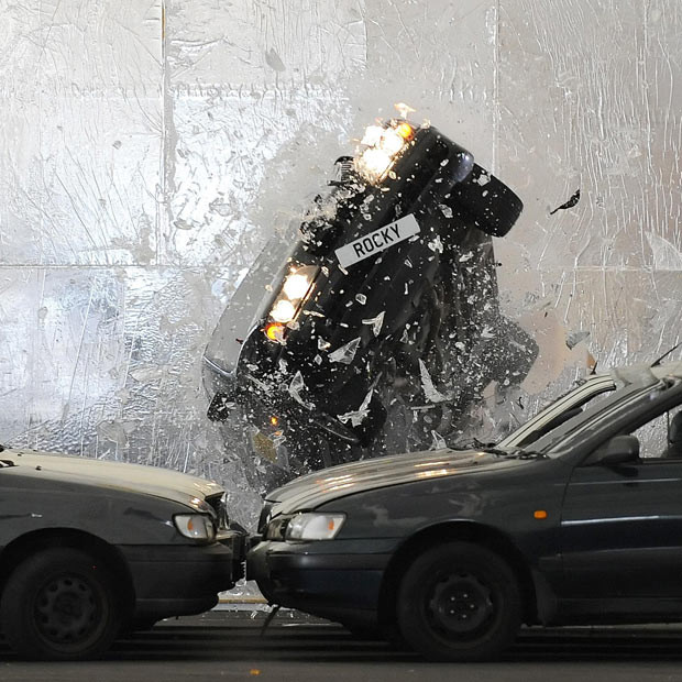 Hollywood stuntman Rocky Taylor, 64, breaks the Guinness World Record for ’largest breakaway glass structure smashed by a car’ at the O2 Arena, in Greenwich, London. Taylor drove a BMW 5 Series up a 3.5-metre ramp and through a six-metre by four-metre glass wall to beat the previous record, set in the making of the James Bond film ’Die Another Day’.