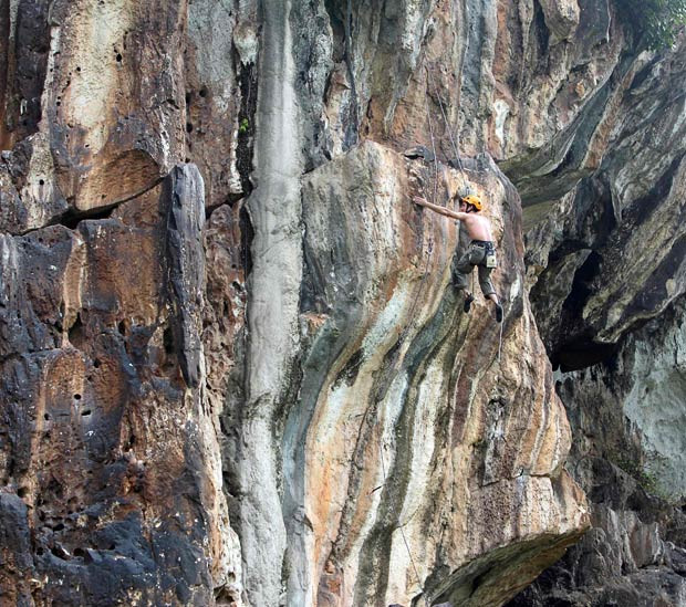 A rockclimber scales a rock face in Quoc Oai, near Ha Noi, Vietnam