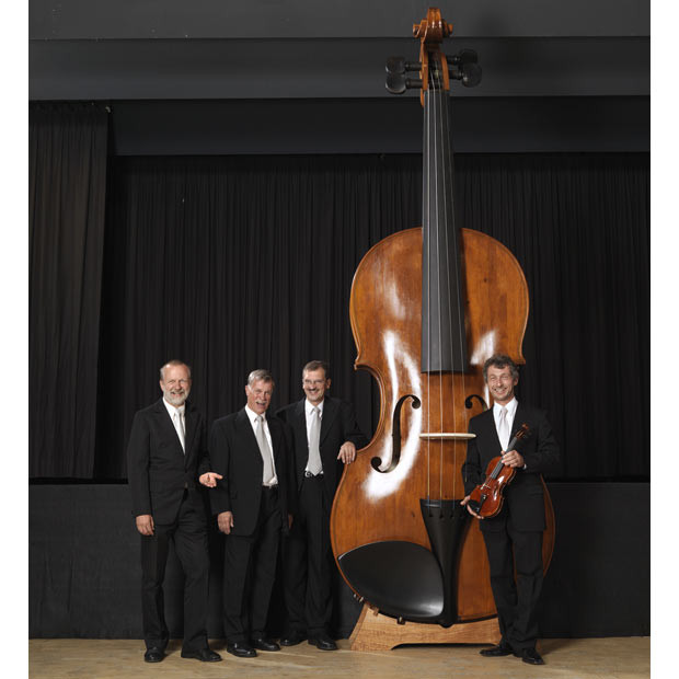 The world’s largest playable violin, which is 4.28 metres tall, 1.45 metres wide, and weighs over 100 kilograms, was made by twelve luthiers in Markneukirchen, Germany. Pictured: Udo Kietcschmaun, Klaus Schlegel, Frank Schlegel, Ekkard Seidl with the giant violin. 