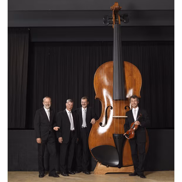 The world’s largest playable violin, which is 4.28 metres tall, 1.45 metres wide, and weighs over 100 kilograms, was made by twelve luthiers in Markneukirchen, Germany. Pictured: Udo Kietcschmaun, Klaus Schlegel, Frank Schlegel, Ekkard Seidl with the giant violin. 