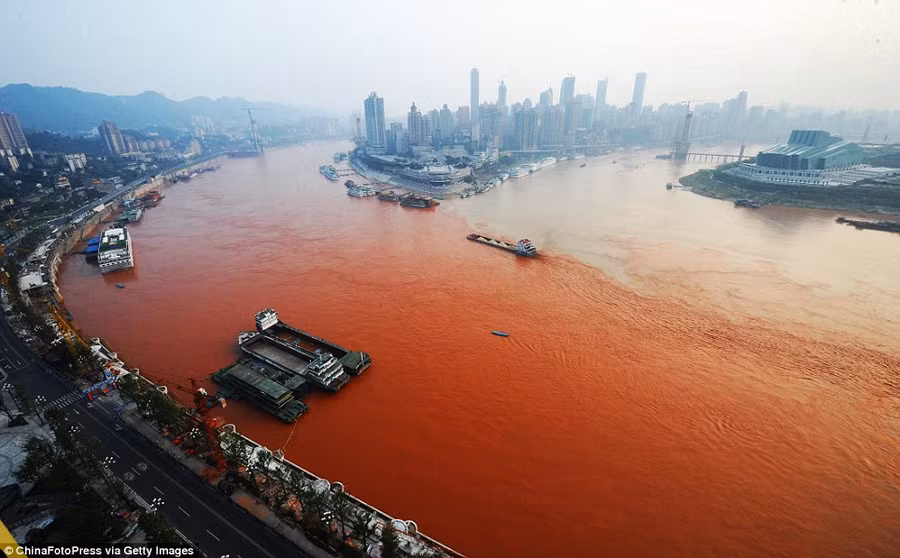 Meeting point: A ship sails across the junction of the polluted Yangtze River (left) and the Jialin River in Chongqing, China, yesterday Read more: http://www.dailymail.co.uk/news/article-2199800/The-river-DID-run-red-Residents-Chinese-city-left-baffled-Yangtze-turns-scarlet.html#ixzz25wcjDEkp