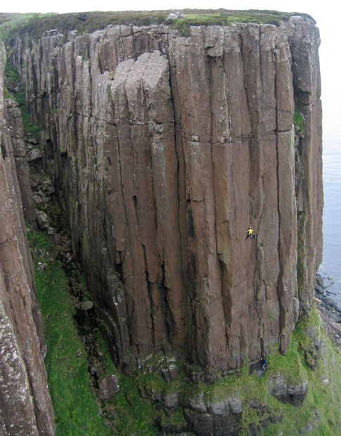 Pippa Whitehouse looks tiny as she clambers up the near-vertical face of the 130-feet high Kilt Rock on the Isle of Skye, Scotland 