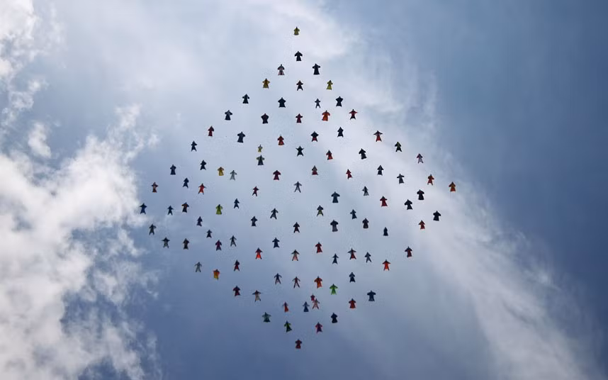 One hundred wingsuit skydivers fall to earth in a diamond formation during a world record attempt above Perris Valley in Southern California 