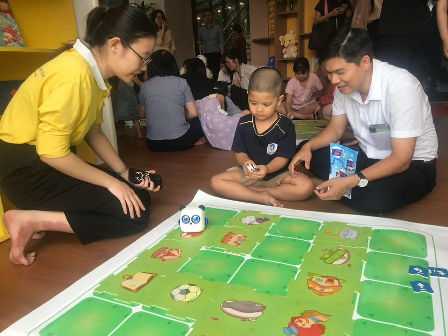 Robotics hấp dẫn cả 2 bố con khi được cô giáo hướng dẫn thực hiện.