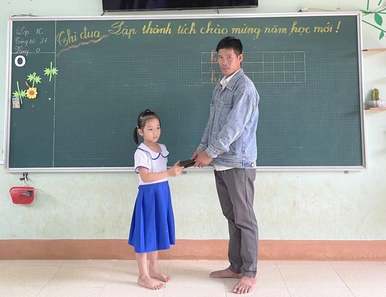 Em Ban Mai trả lại chiếc ví nhặt được cho người mất.