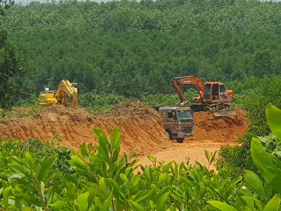 Hai máy múc đất lên xe để vận chuyển ra ngoài.