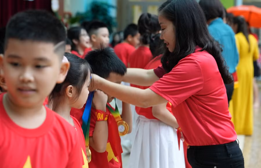 Cô Hiệu trưởng Nguyễn Phương Hoa trao huy chương cho học sinh có thành tích trong thể dục thể thao của trường