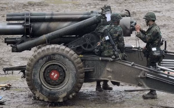 South Korean Army soldiers gather near a howitzer as they take part in a military drill 