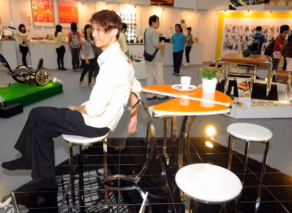 A staff worker sits on a designed chair
