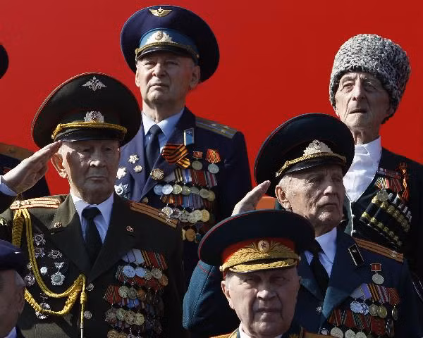World War Two veterans salute as they watch the military parade in Red Square 