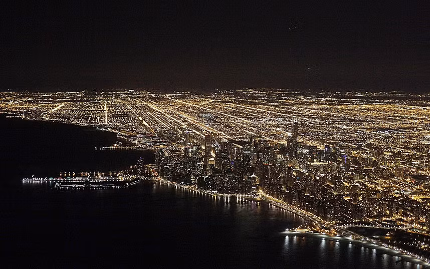 An aerial view at night of the downtown Chicago skyline