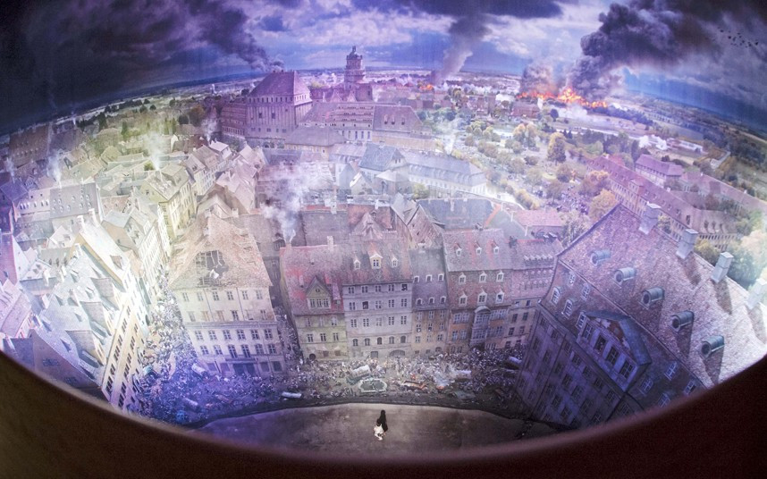 A visitor walks in front of the monumental panoramic picture 