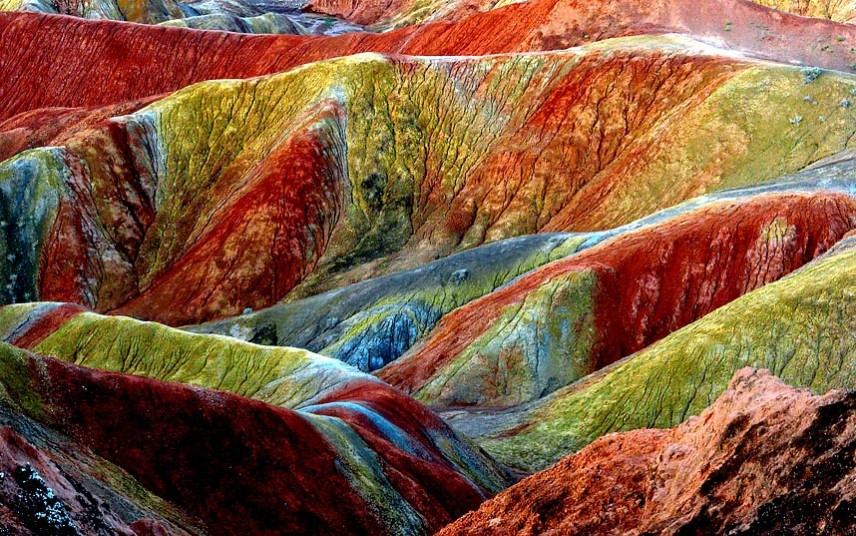 The stunning Danxia Scenic Area in Zhangye City, northwest Chinas Gansu Province. Danxia, which means rosy cloud, is a special landform formed from reddish sandstone that has been eroded over time into a series of mountains surrounded by curvaceous cliffs and many unusual rock formations.