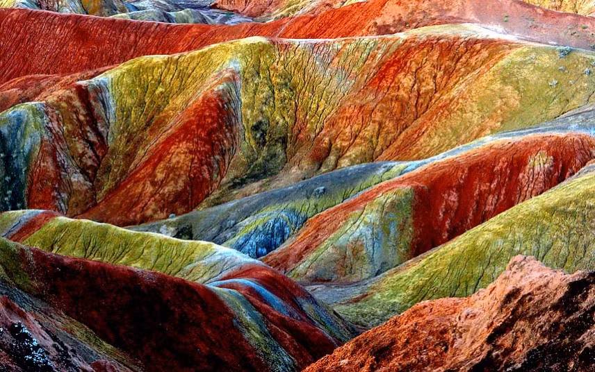 The stunning Danxia Scenic Area in Zhangye City, northwest Chinas Gansu Province. Danxia, which means rosy cloud, is a special landform formed from reddish sandstone that has been eroded over time into a series of mountains surrounded by curvaceous cliffs and many unusual rock formations.