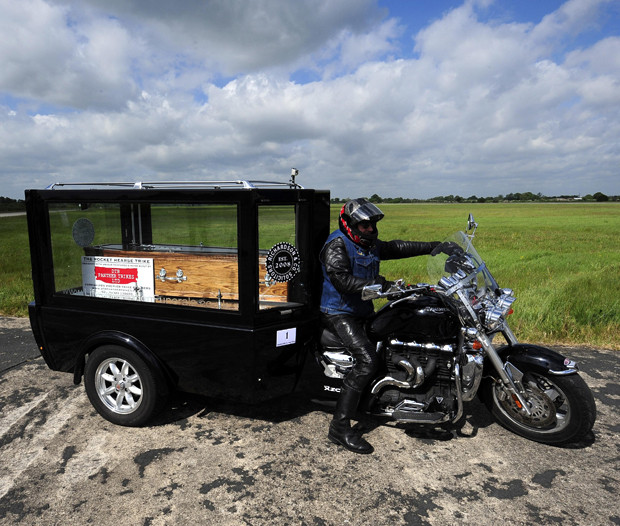 The Reverend Ray Biddiss parks his motorbike after setting a Guinness World Record for the world’s fastest motorcycle hearse after he set a new record of 114mph at Elvington airfield in Yorkshire
